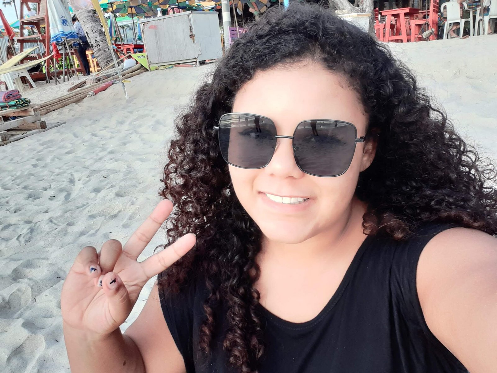 Author on a beach while living in Thailand as a woman of color