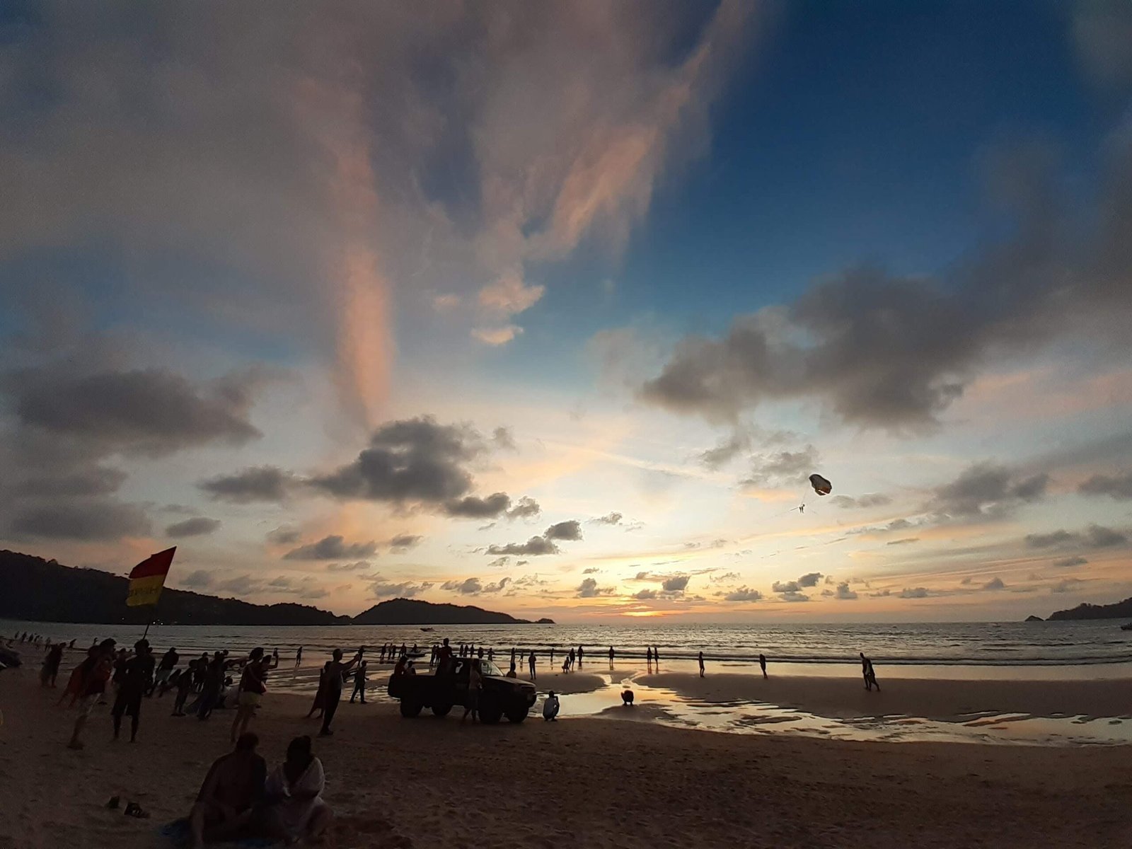 Sunset over a busy beach in Thailand