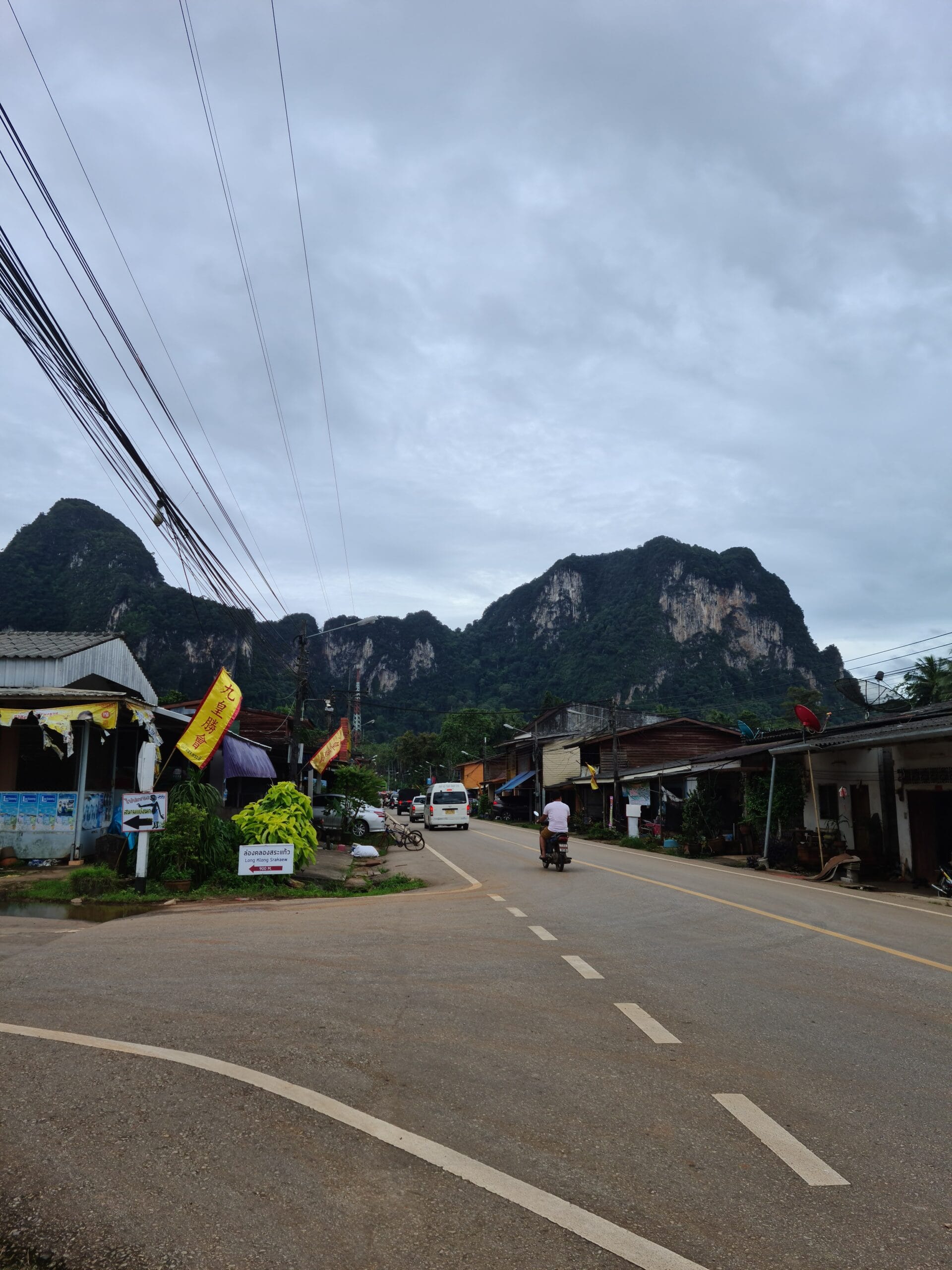 Everyday road in Krabi beneath limestone mountains