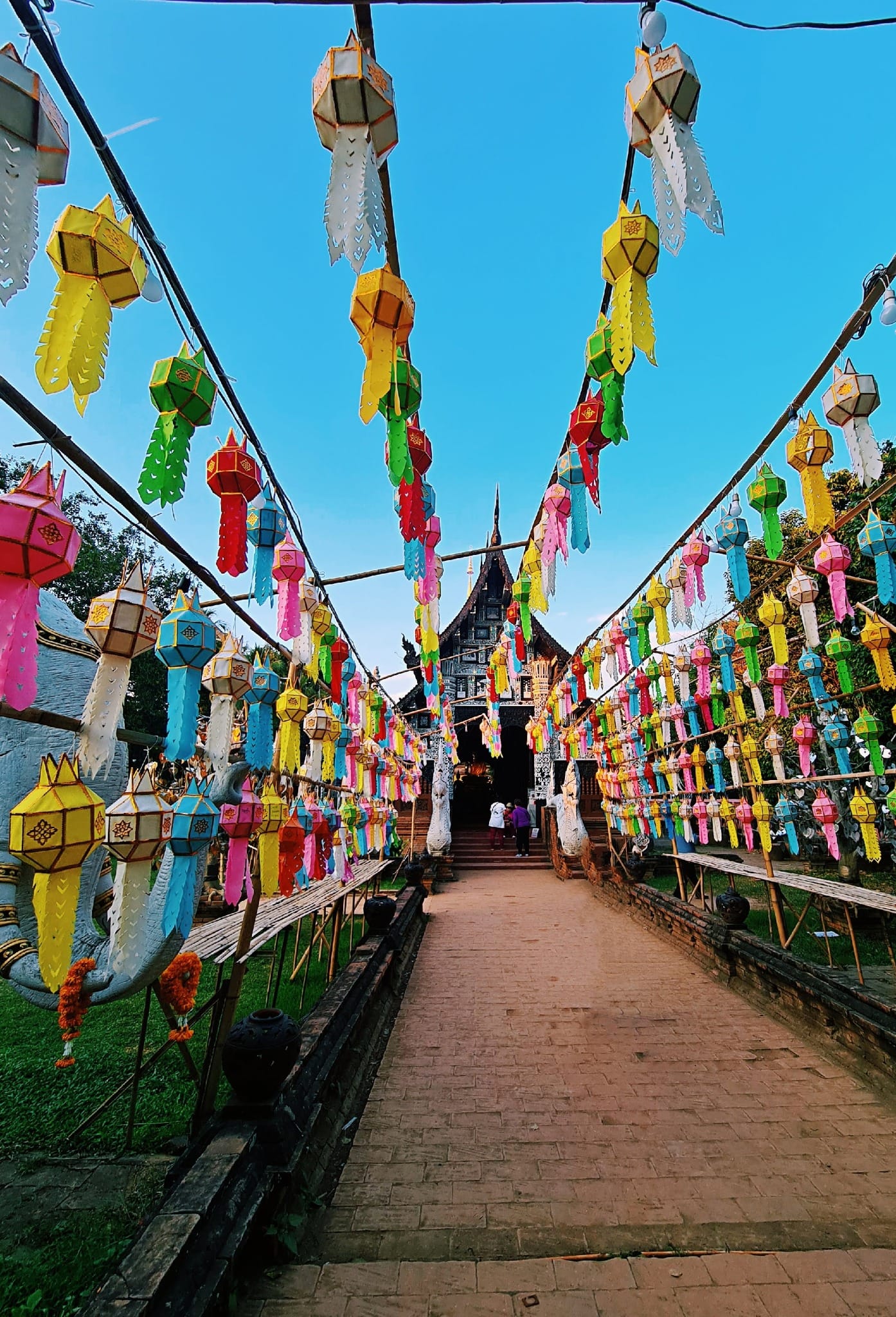 Colorful lanterns lining a temple walkway in Chiang Mai