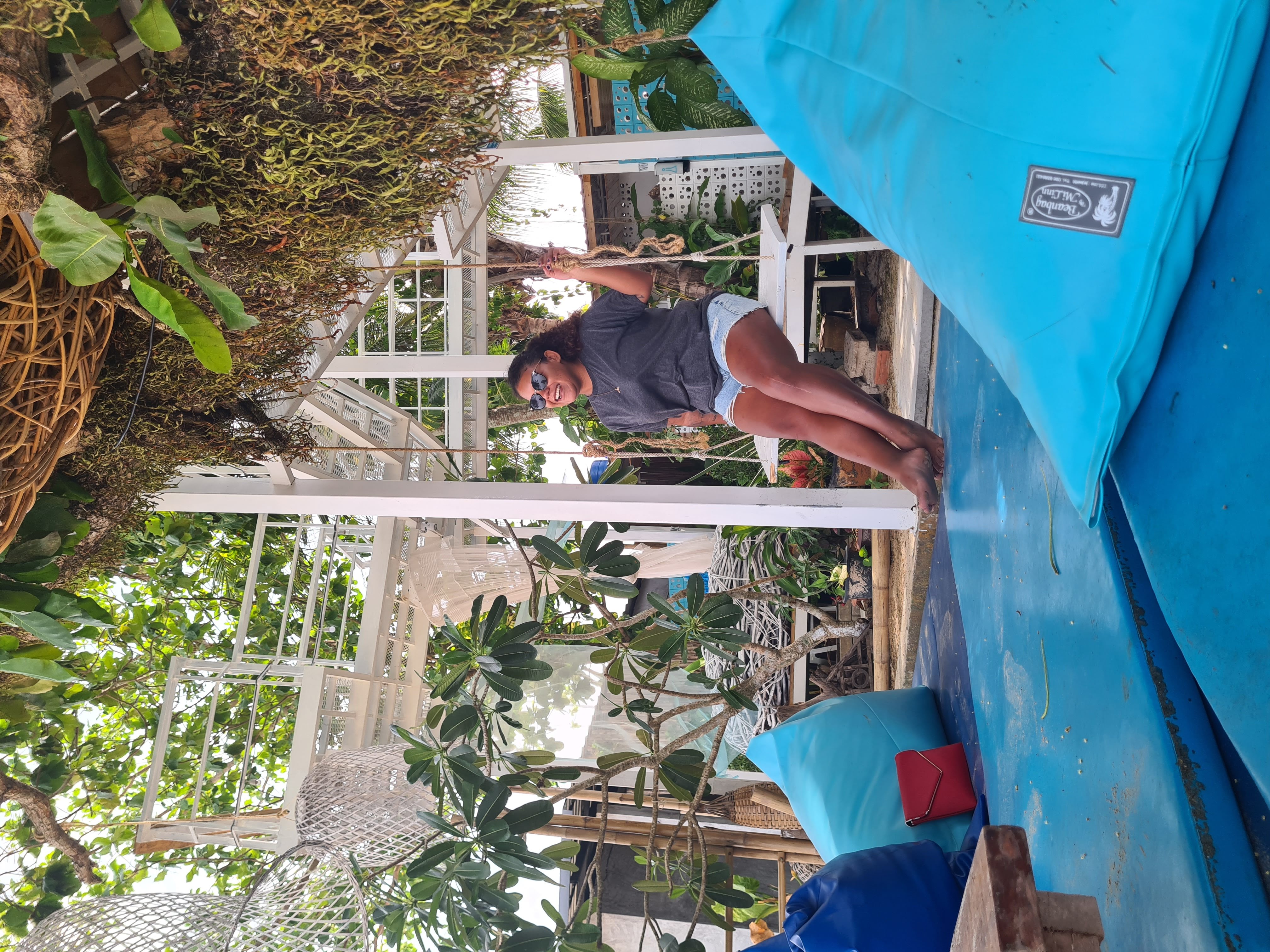 Nana sitting alone on a swing in Thailand