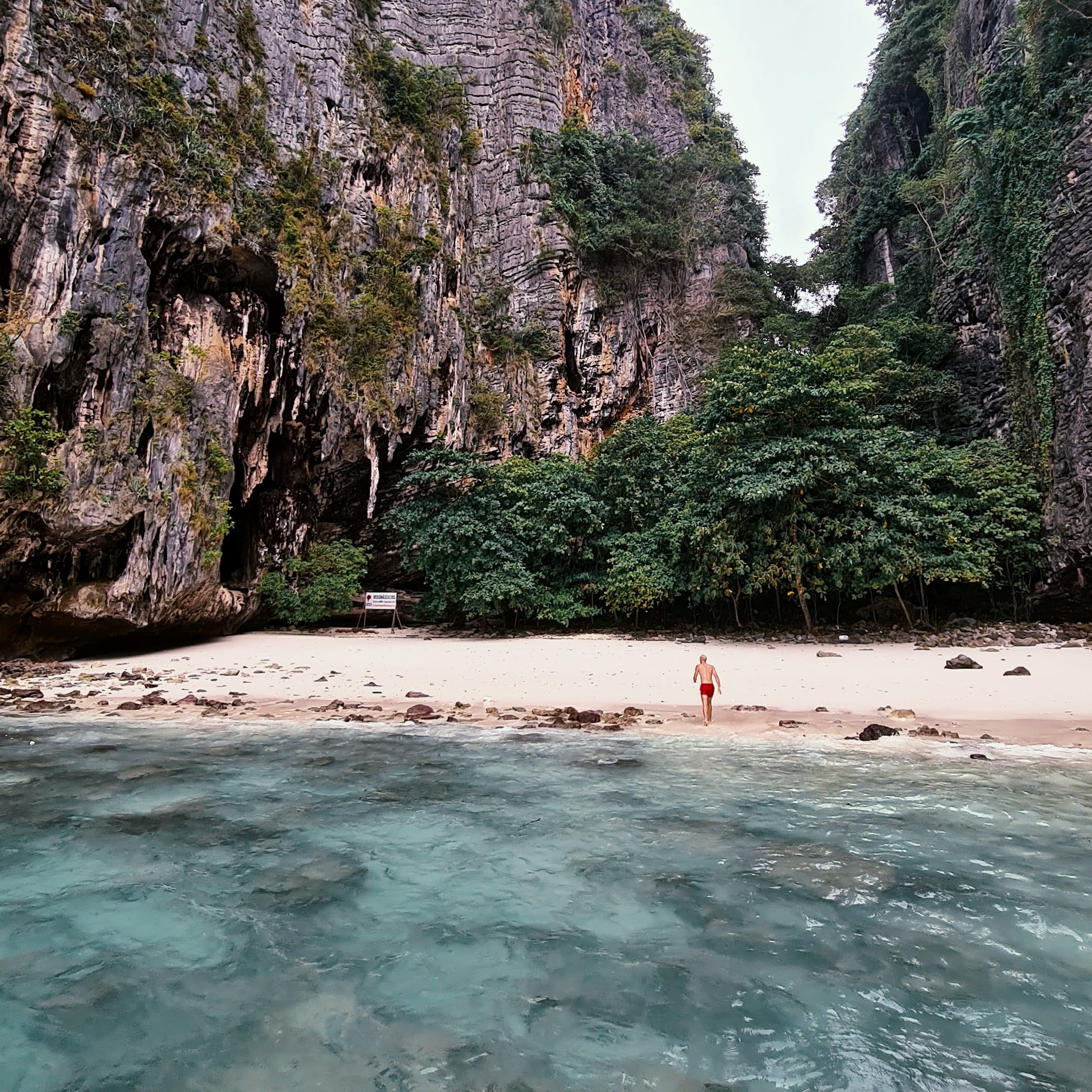 Small Railay beach enclosed by limestone cliffs