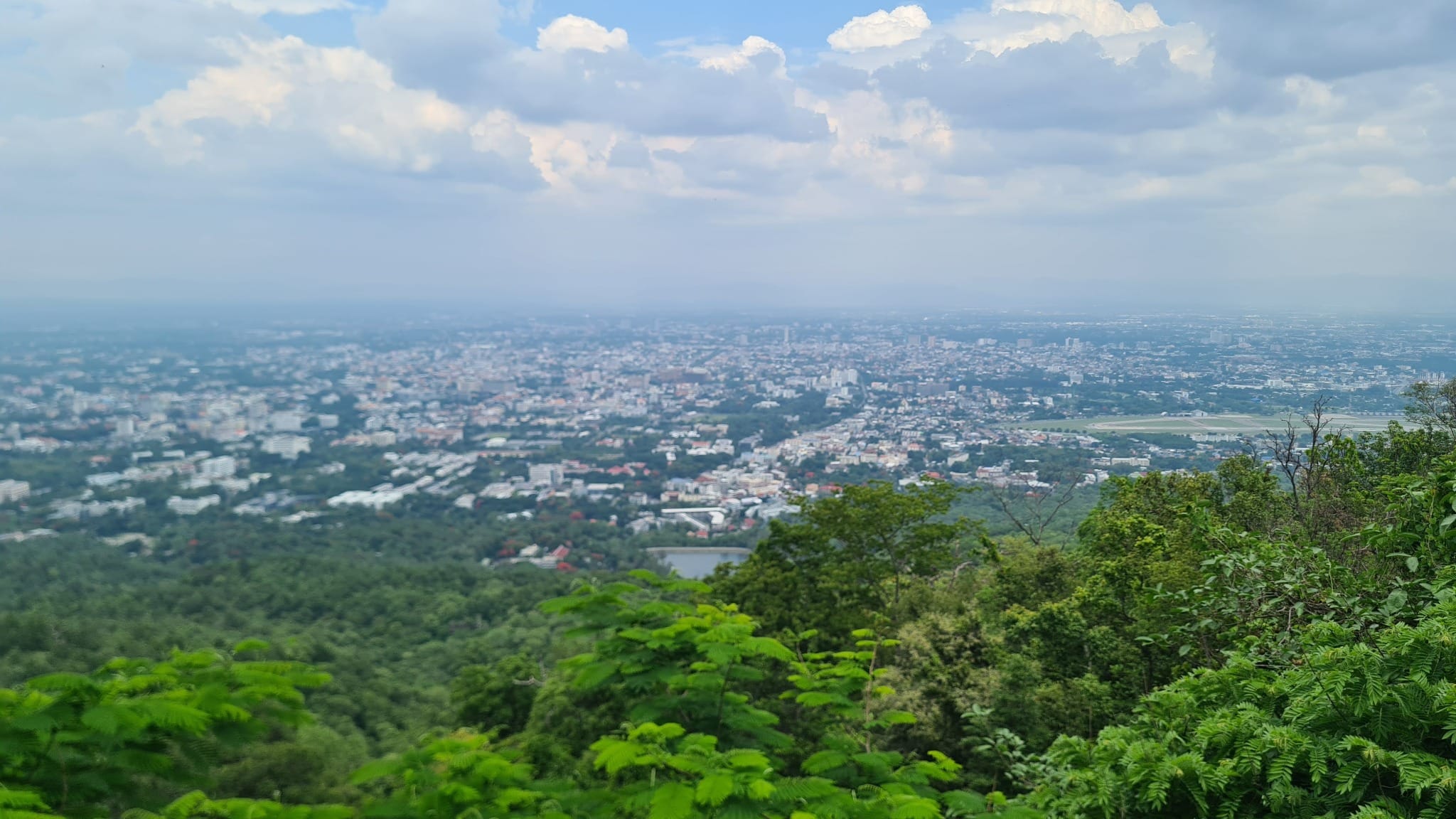 Wide view over Chiang Mai city and surrounding green hills