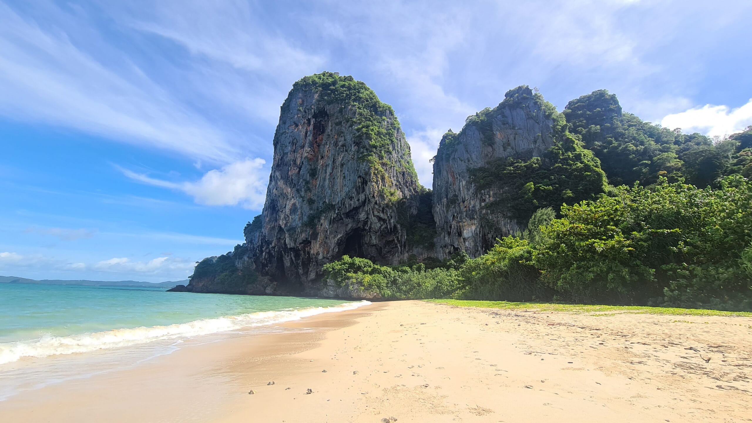 Quiet Krabi beach backed by dramatic limestone cliffs