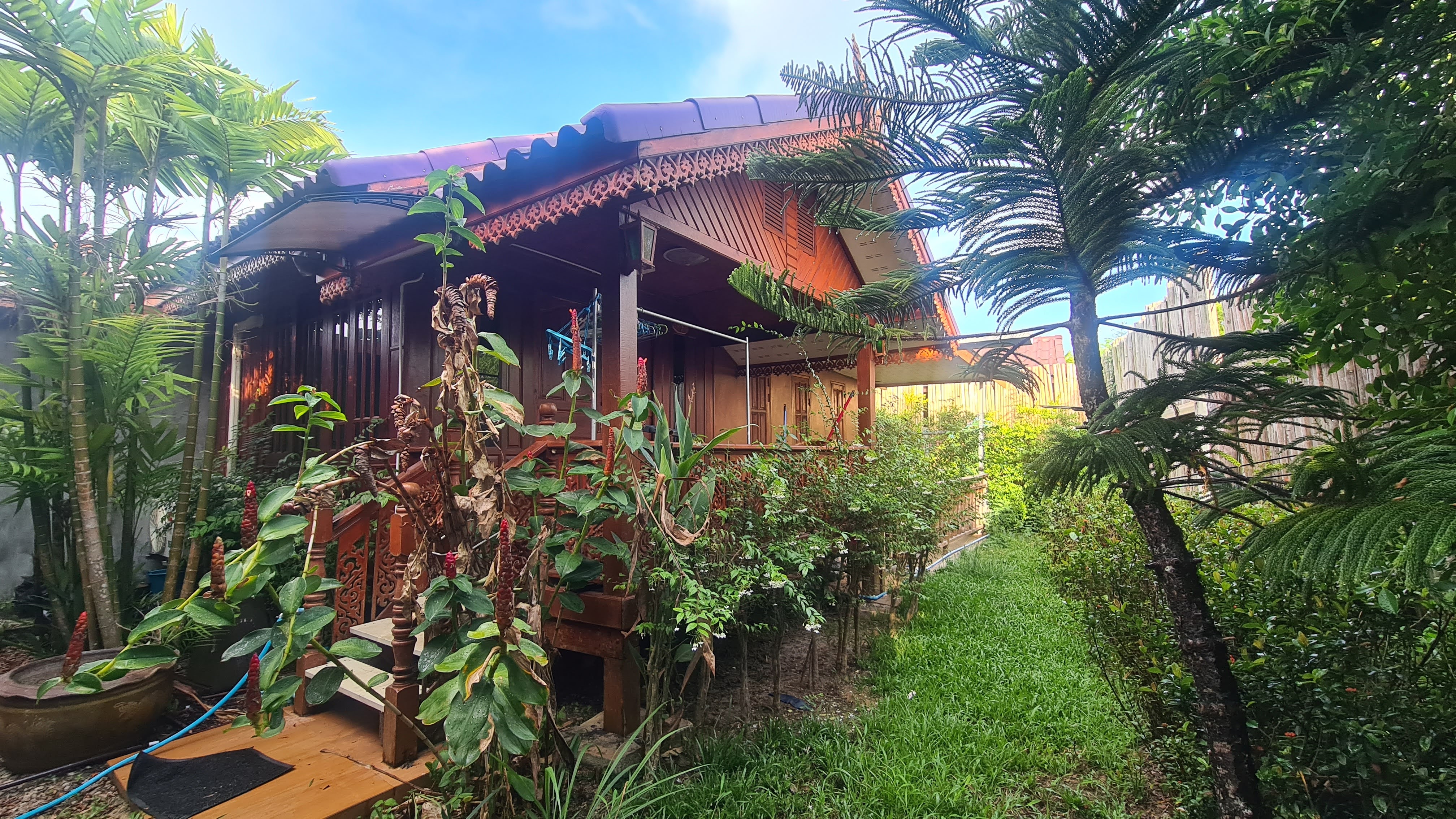 Nana's former house in Thailand surrounded by tropical plants