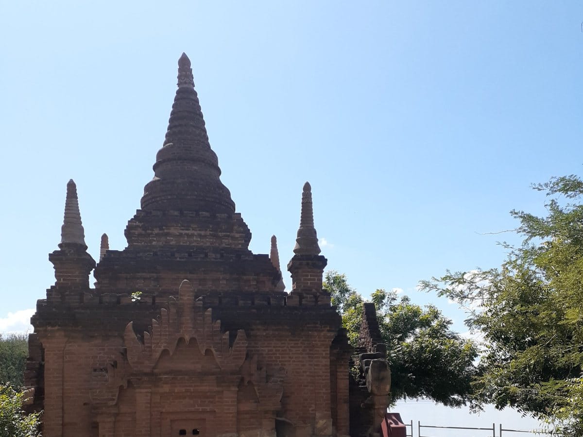 Small brick temple surrounded by greenery in Bagan, Myanmar