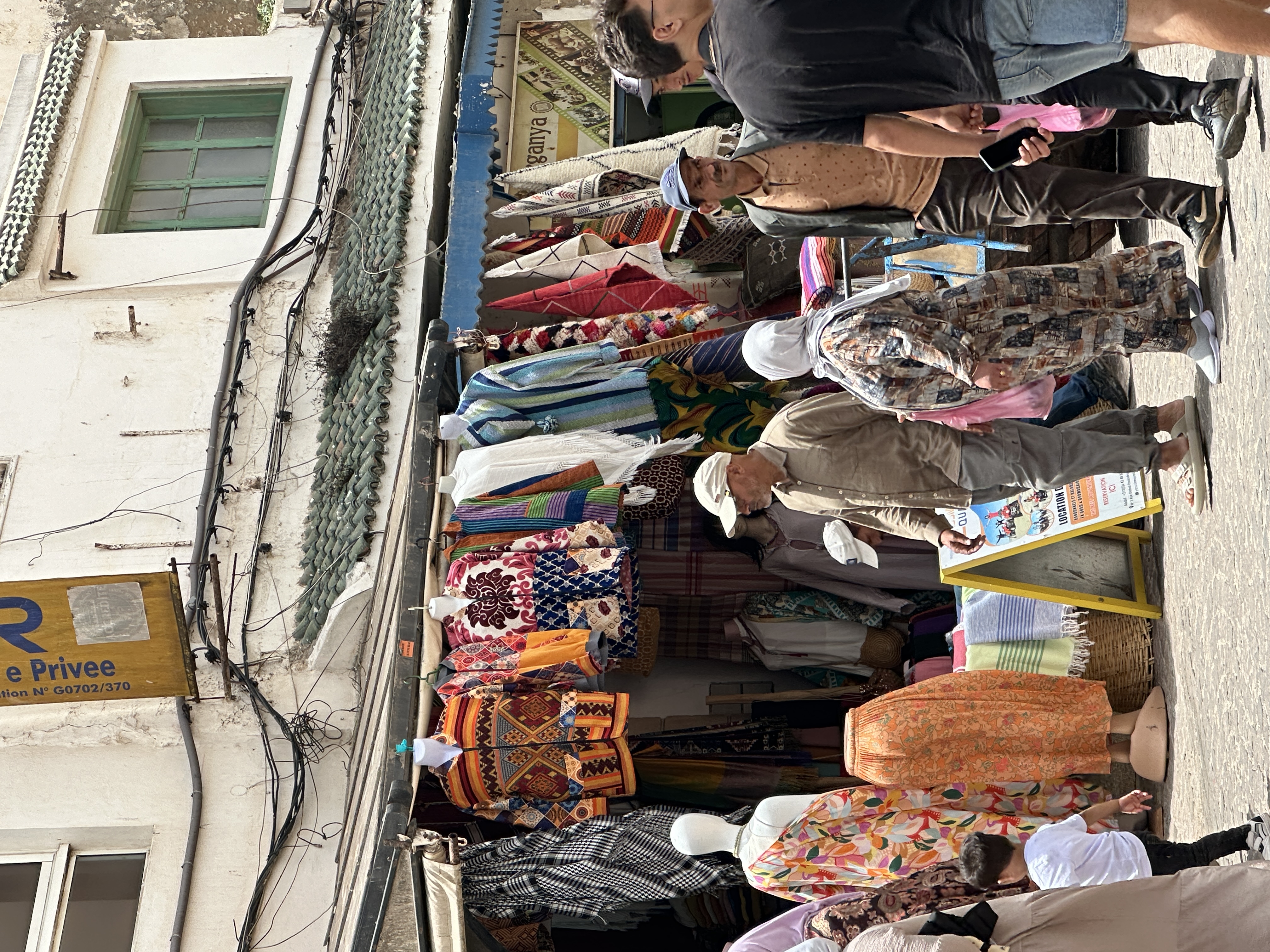People walking through a busy market street in Morocco