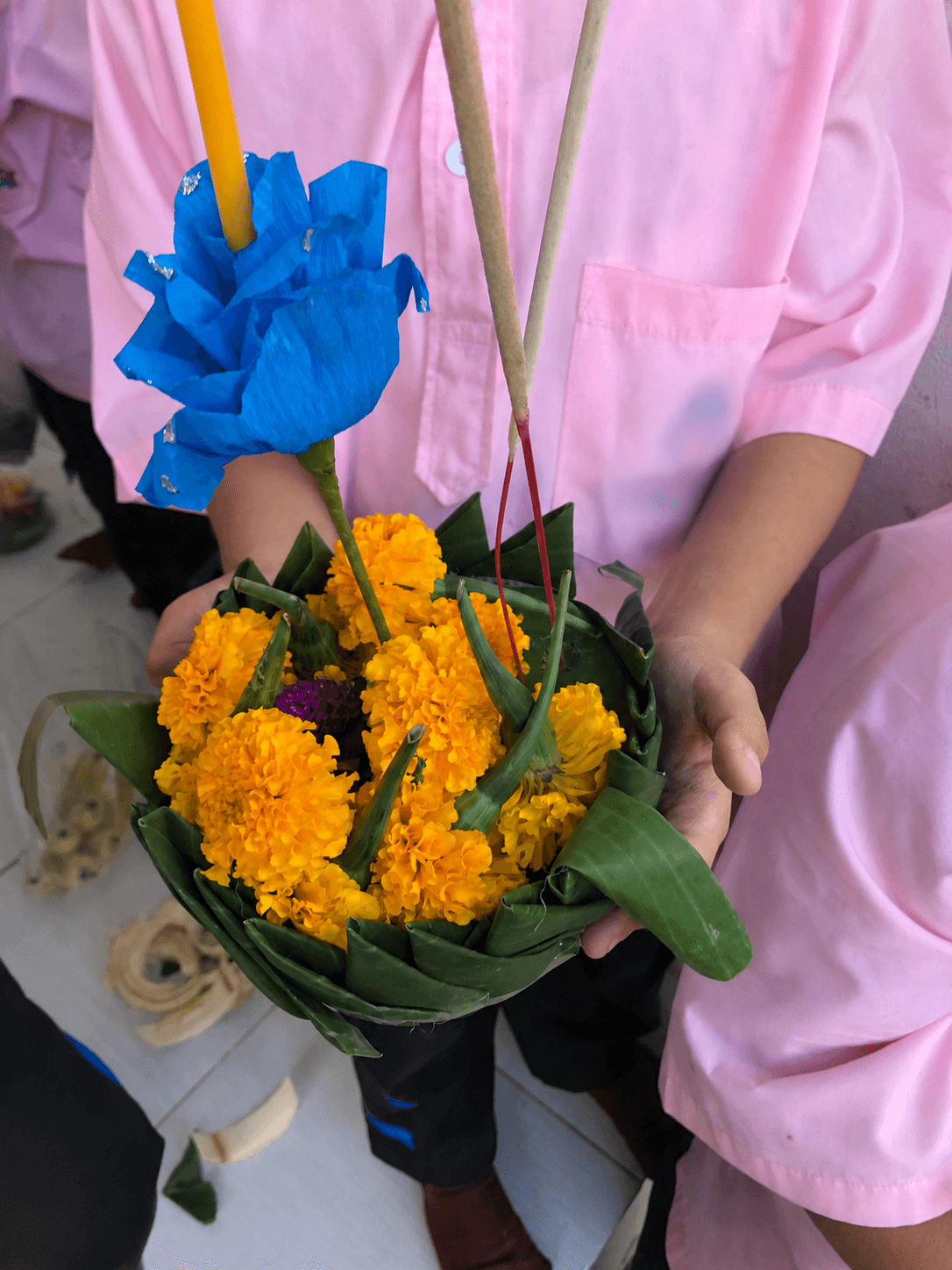 Students making krathongs in a Thai school with faces and identifying details blurred for privacy