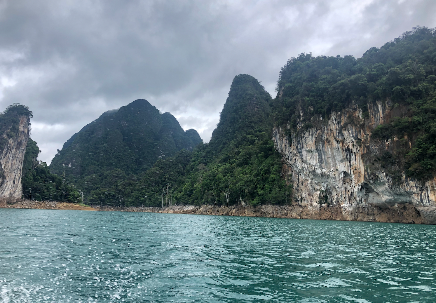 Limestone cliffs rising above Cheow Lan Lake in Khao Sok National Park