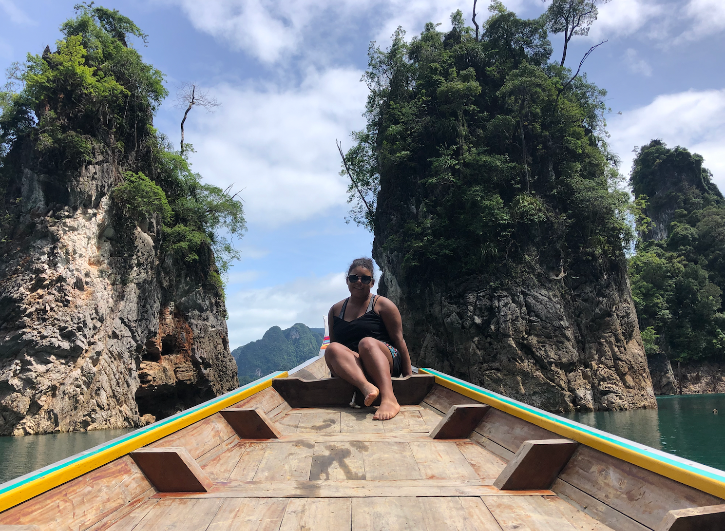 Traveler sitting on a longtail boat on Cheow Lan Lake in Khao Sok National Park