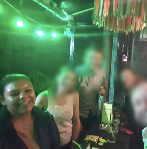 Nana at a social gathering in Thailand with other guests' faces blurred for privacy