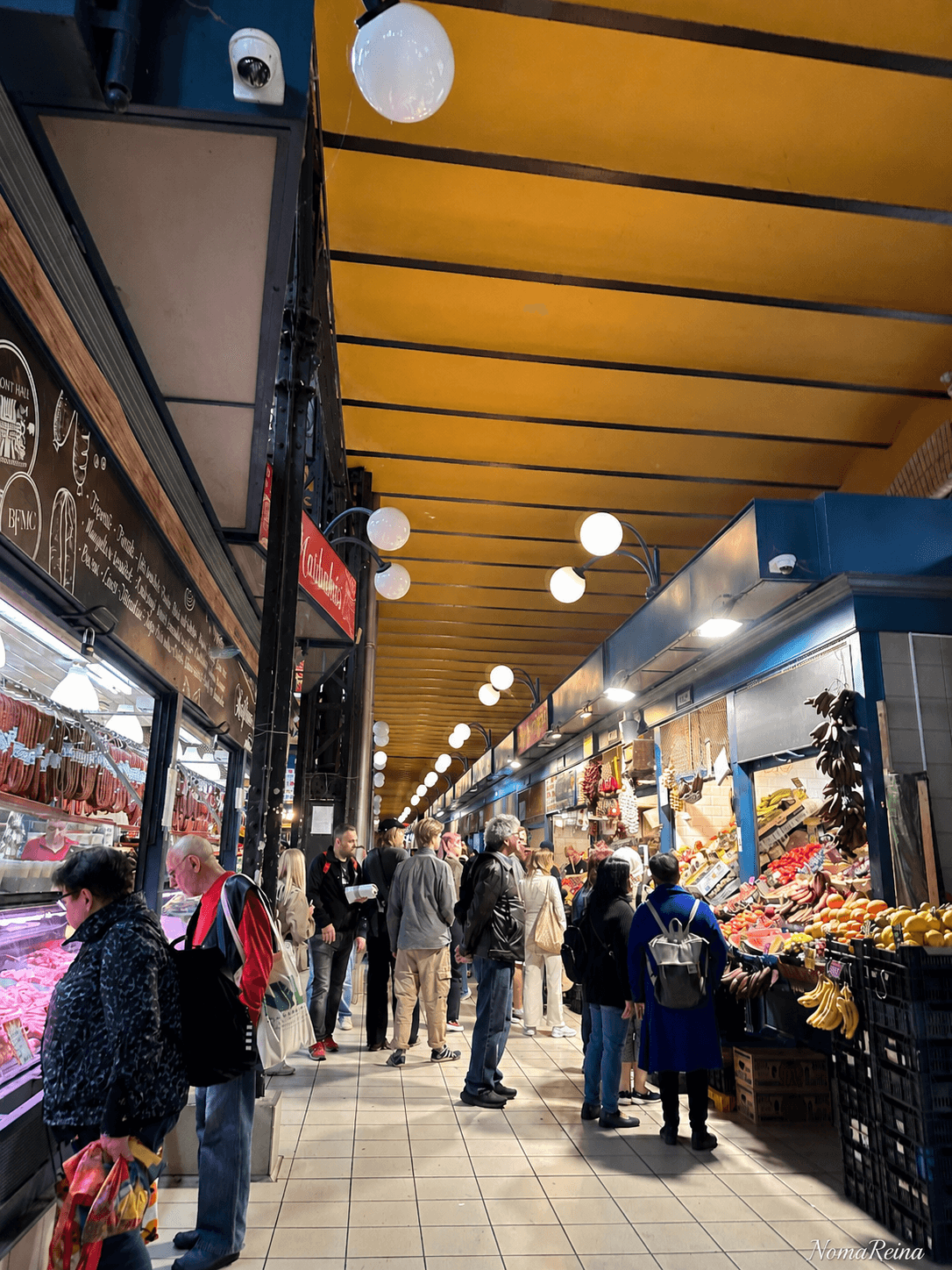 People shopping inside a busy indoor market