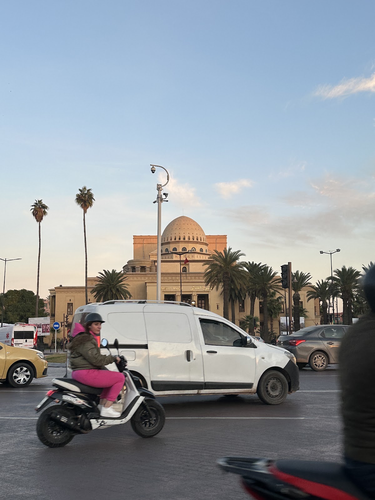 Motorbikes, cars and everyday traffic moving through a city street