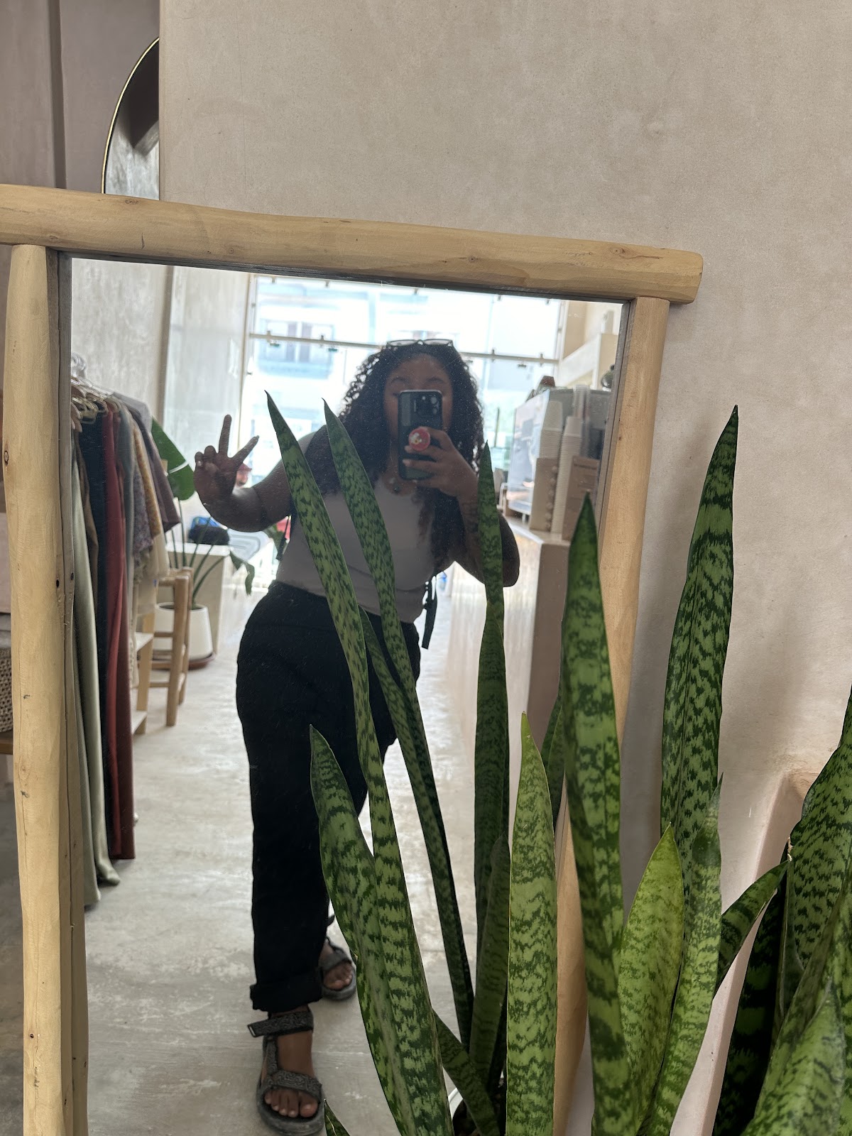 Nana taking a mirror photo while out in an everyday shopping space